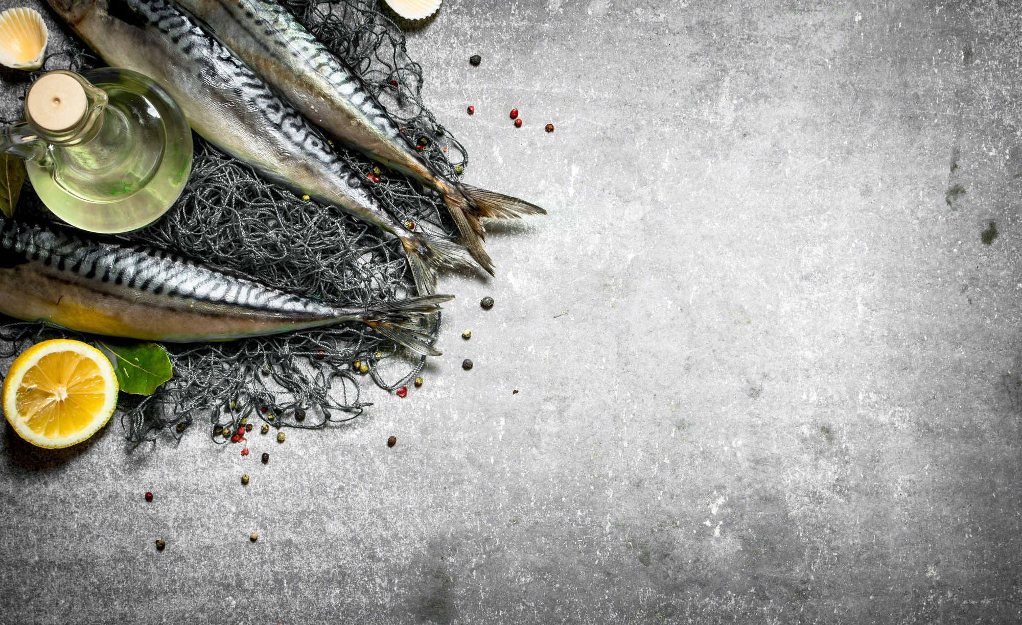 Fish with olive oil on a fishing net.