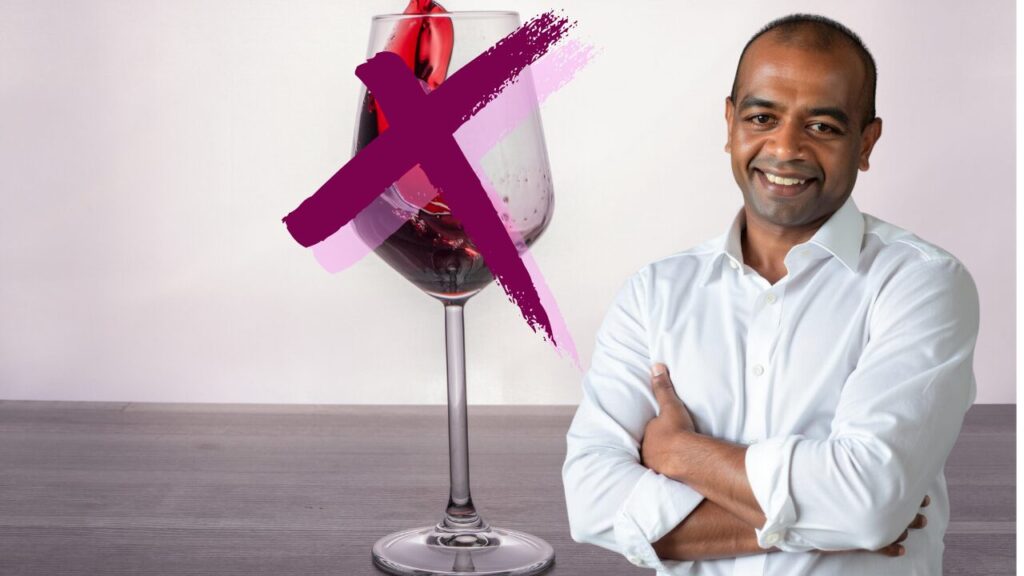 The Great Alcohol Lie: How Science, Media, and Industry Sold Us Poison as Medicine 8 Dr. Bomi Joseph with a wine glass behind him with a bold red X over it, symbolizing the truth about alcohol’s harms.
