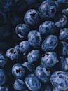 A vibrant close-up of a heap of fresh, juicy blueberries, showcasing their natural beauty and nutritional appeal.