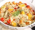 Delicious vegan quinoa salad with tomatoes, oranges, and fresh herbs.