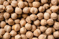 Detailed close-up image of raw chickpeas, highlighting texture and natural color.