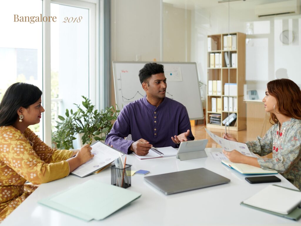 Three young Indian programmers meeting in a conference room in Bangalore in 2018.