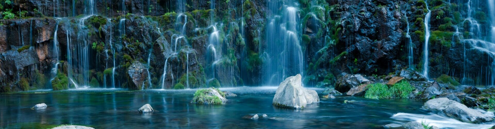 Clear mineral spring water emerging from natural rock, representing the ionic mineral content of natural water beyond simple H₂O — Busting Nutrition Myths Article VII by Bomi Joseph MD PhD